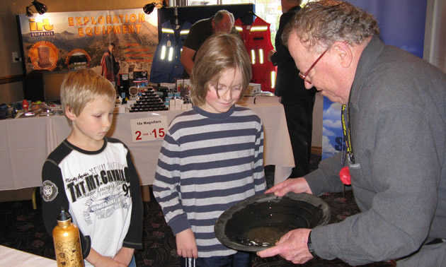 Photo of two children observing gold pan demonstration