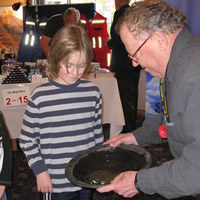 Photo of two children observing gold pan demonstration