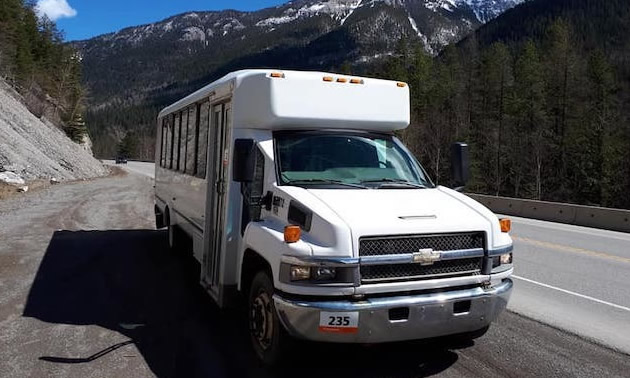 Small passenger bus on highway.