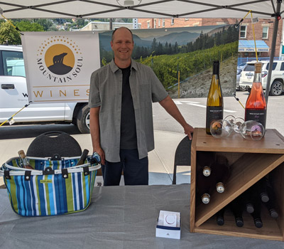 Trevor Miller, owner of Mountain Soul Wines, at farmers market booth. 