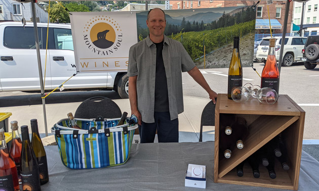 Trevor Miller, owner of Mountain Soul Wines, at farmers market booth. 