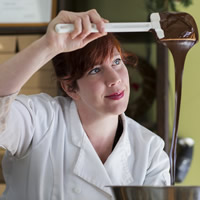 Trish Dyer of Mountain Nugget Chocolate Company, admiring the chocolate streaming from her spatula