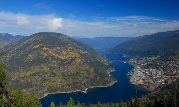 An aerial view of Nelson surrounded by the Selkirk Mountains and Kootenay Lake.