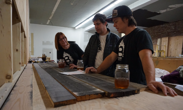 Backroads Brewing Company is putting the finishing touches on its new brewery and will open sometime this winter. (L to R) Tracey Brown, CFO; Mike Kelly, brewmaster; and Brent Malysh, CEO.