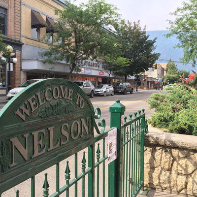 Nelson welcome sign and downtown Nelson. 