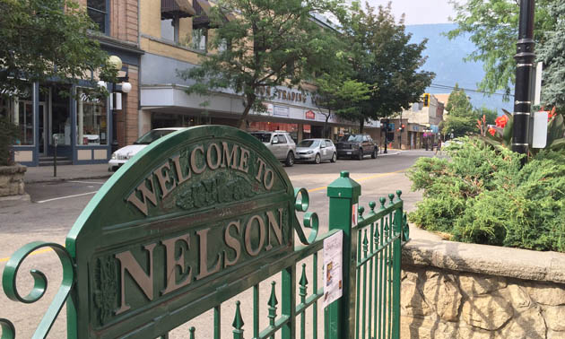 Nelson welcome sign and downtown Nelson. 