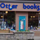Storefront carrying the words Otter Books above large windows showing displays of books