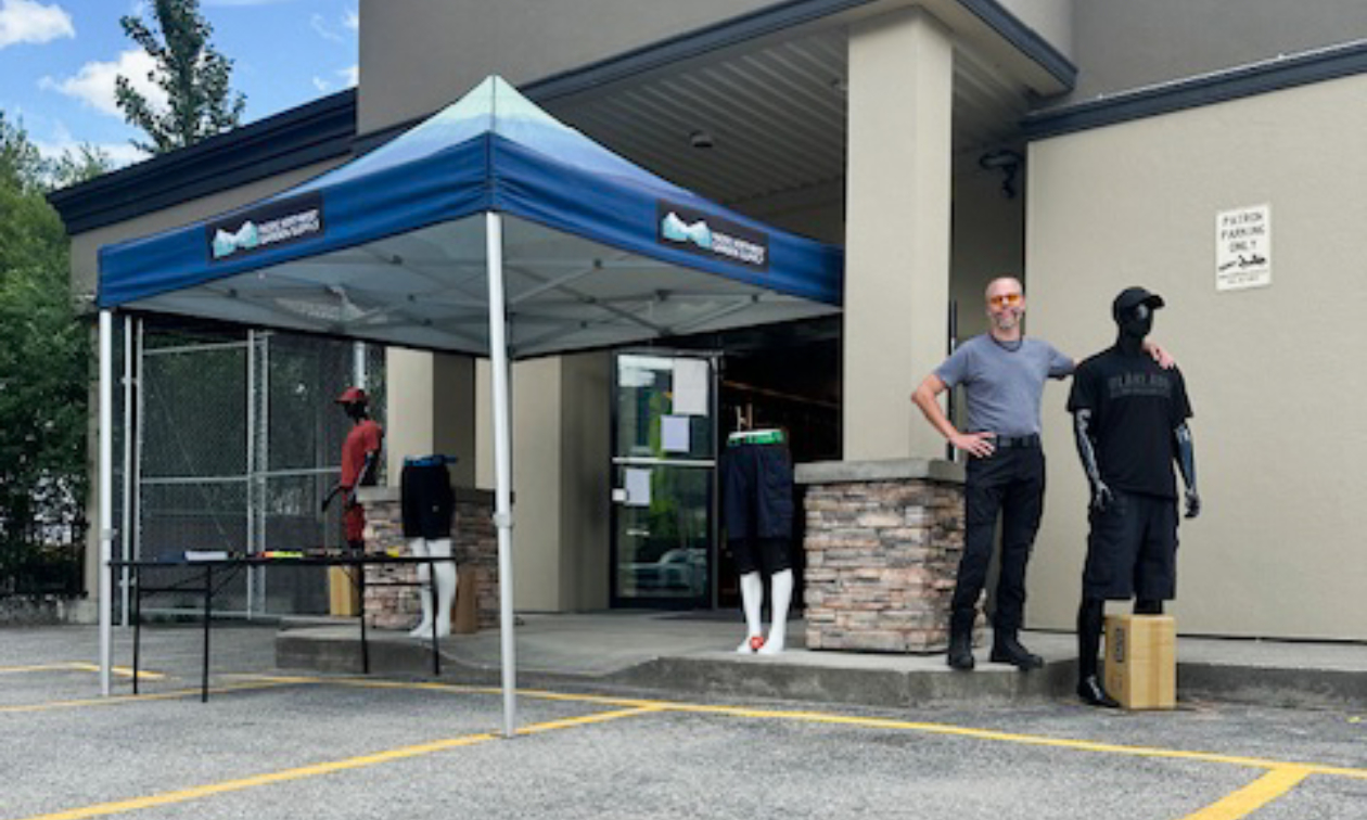 David Robinson welcomes customers to the PNW Mercantile & Supply Co. in Nelson, B.C., showcasing a selection of clothing and gear under the main entrance tent.