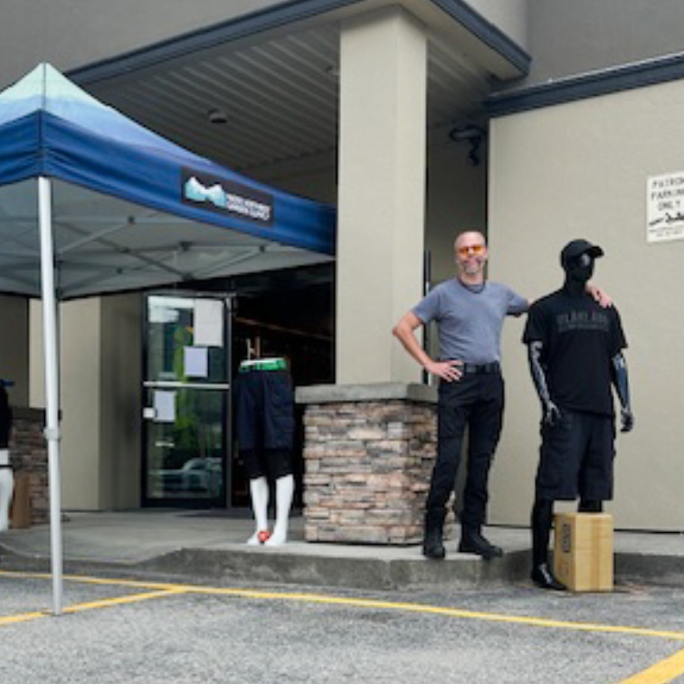 David Robinson welcomes customers to the PNW Mercantile & Supply Co. in Nelson, B.C., showcasing a selection of clothing and gear under the main entrance tent.