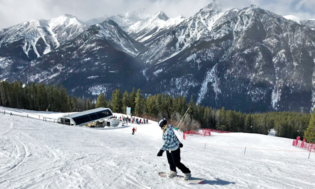 Skier at Panorama Resort, mountains in background. 