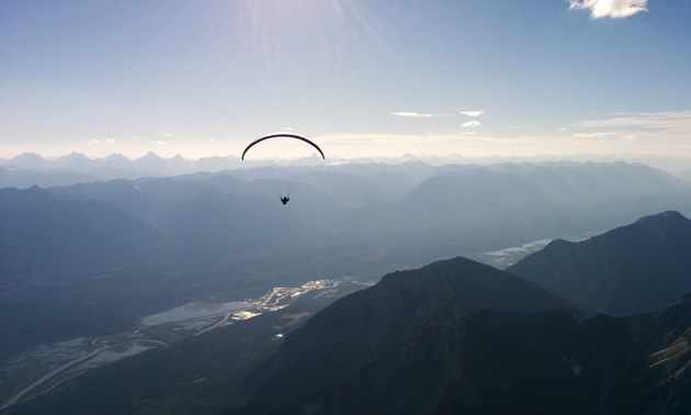 A lone paraglider flies above the Columbia Valley in southeastern British Columbia.