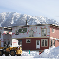 A row of flat-roofed houses under construction