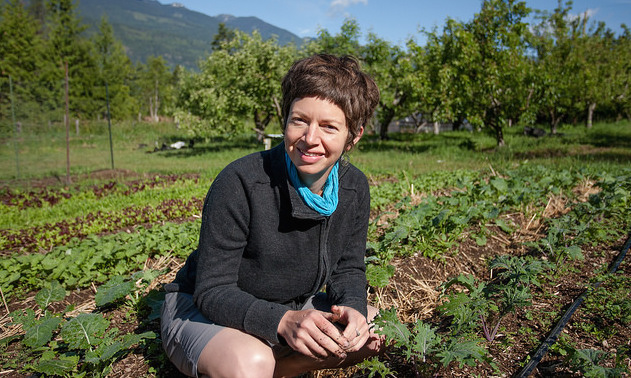 Paris Marshall Smith, kneeling in a large cultivated field. 