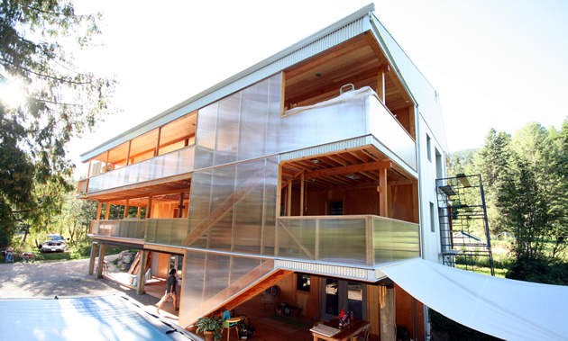 A long Passive House triplex with two full-length decks nears completion.