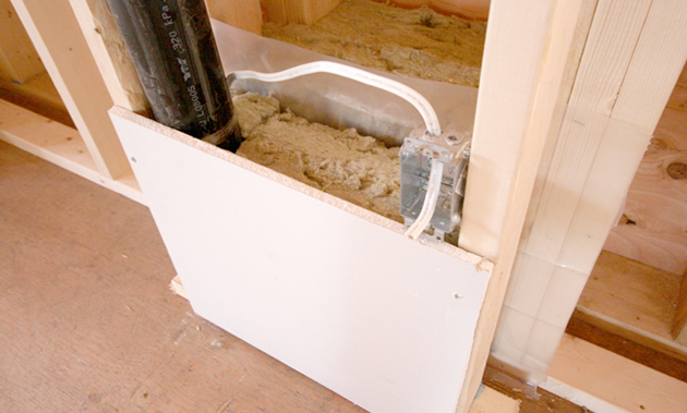 A wall assembly shows thick studs and heavy insulation.