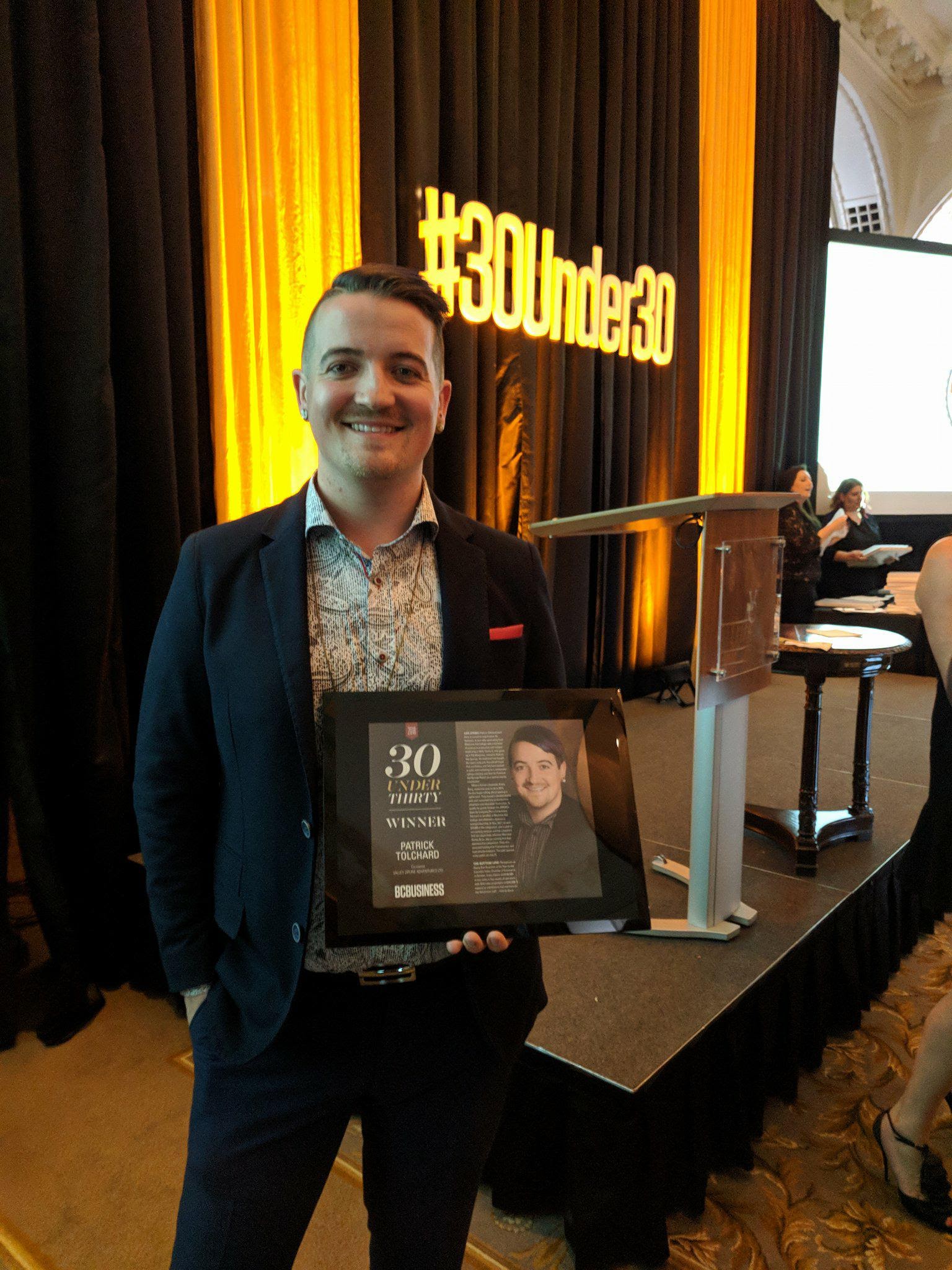 Patrick Tolchard holding his 30 under 30 award. 