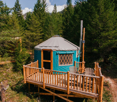 A yurt in the middle of the forest. 