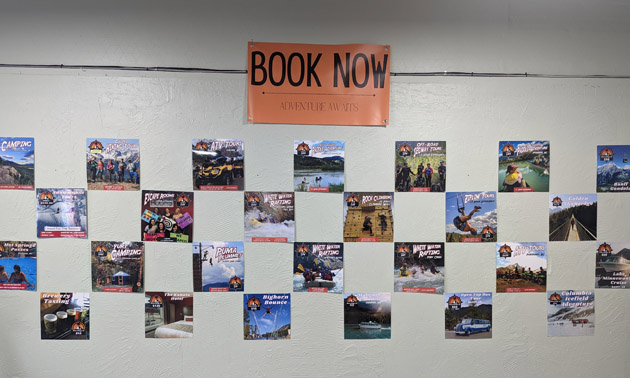 Wall of signs at Kootenay Adventure Collective showing the different adventures that are available. 