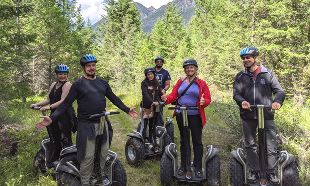 A group of people all standing on segways.