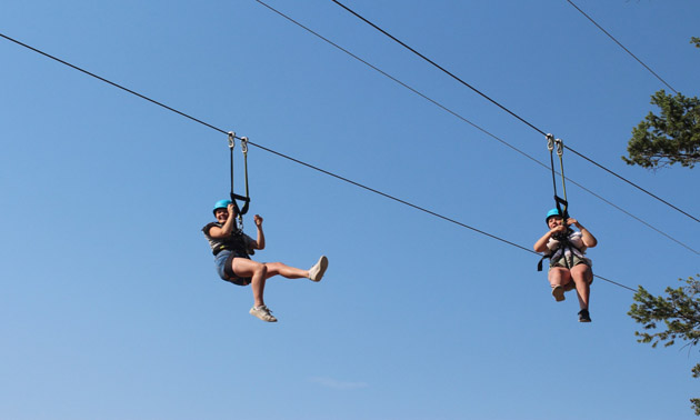 Two people on zipline. 