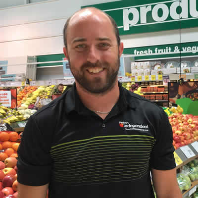 Brian Pealow, owner of Pealow's grocery store in Creston, in the store's colourful produce department