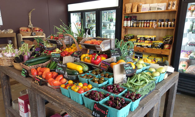 Assortment of fresh produce, wine in background. 