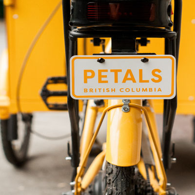 Close-up of license plate on e-bike that says 'Petals - British Columbia'. 