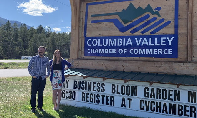 Executive director Pete Bourke and visitor centre supervisor Sarah Miller of the Columbia Valley Chamber of Commerce, beside the chamber sign on Highway 93/95 