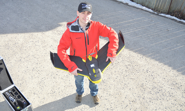 Peter LeCouffe, Operations Manager, at Harrier Aerial Surveys shows off a fixed wing drone.