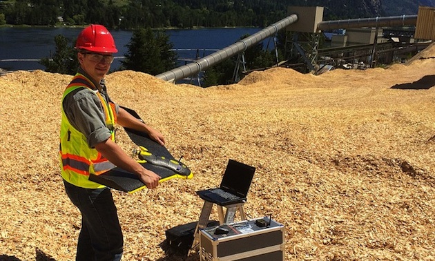 Peter LeCouffe, Operations Manager, shown holding the Fixed Wing Drone at the Celgar pulp mill in Castlegar BC.