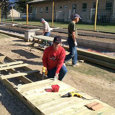 Volunteers build the raised planters for the Rotary Gardens in Radium Hot Springs.