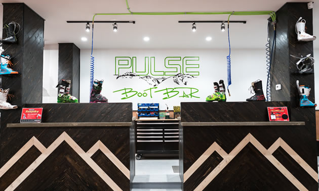 Store front at Pulse Boot Lab and Ski Co., showing wooden front desk and 'boot bar' beyond. 