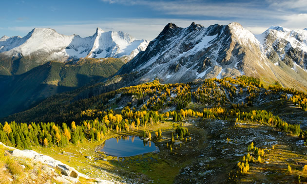 View of towering mountains, with alpine slopes below. 