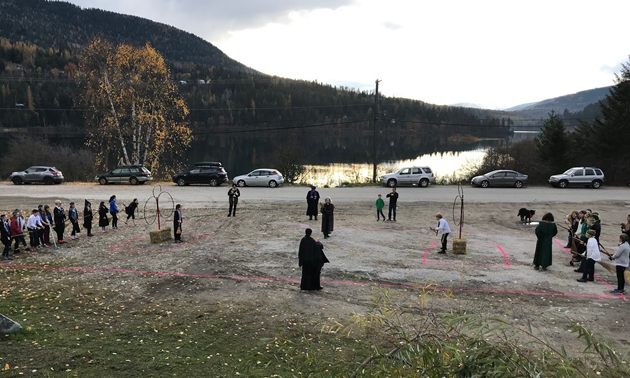 Group of kids dressed in wizard robes playing Quidditch. 