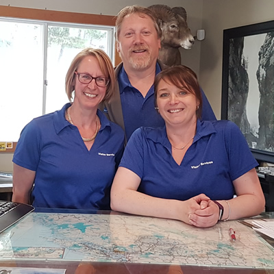 (L to R) Roberta Hall, Kent Kebe and Kara Cassidy welcome people to the Radium Hot Springs Visitor Centre.