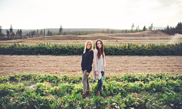 Natasha Benson (L) and Julie Taylor, owners of The Raw House, are standing in a field of beets.