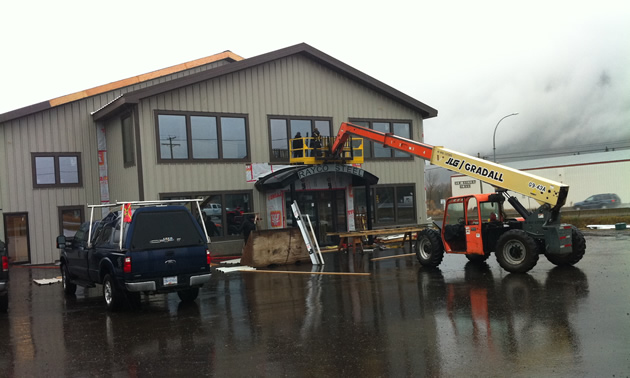 Photo of a building with machinery parked nearby