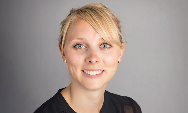 A headshot of Dr. Rebecca Kolbenson with a big smile on her face