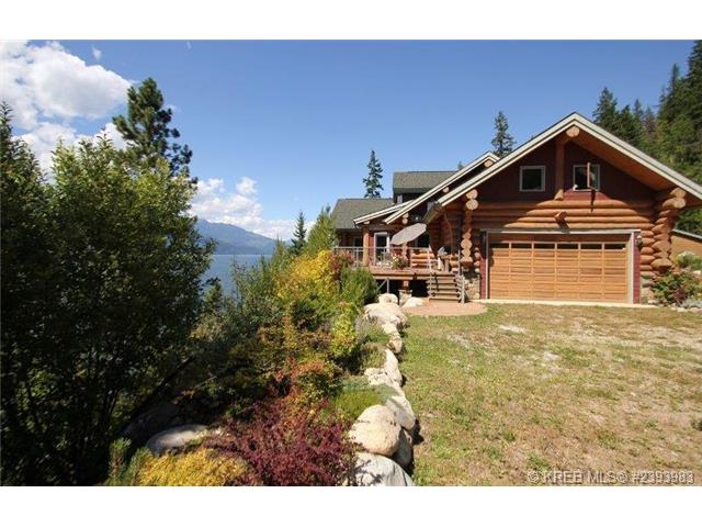A view of the outside of the log home, sitting on a hill overlooking Kootenay Lake. 