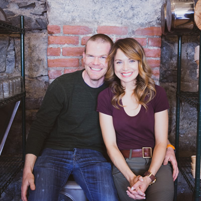 The two owners of The Purist Pantry are shown seated: Todd and Melinda Kopet.