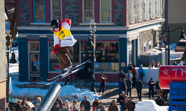 Boarders flying through air doing tricks. 