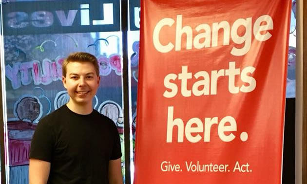 Event Associate Seamus Damstorm displays the United Way banner during a recent fundraising campaign.