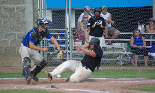 Ball player slides in at home plate