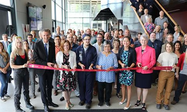 The official ribbon cutting for the Silver King Campus Refresh project was handled by (middle L-R) Selkirk College President Angus Graeme, Nelson-Creston MLA Michelle Mungall, Millwright/Machinist Program student Kai Roenspiess, Elder Anne Jimmie, AEST Minister Melanie Mark and Kootenay West MLA Katrine Conroy.