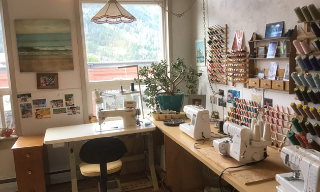Interior view of sewing studio with machines set up. 
