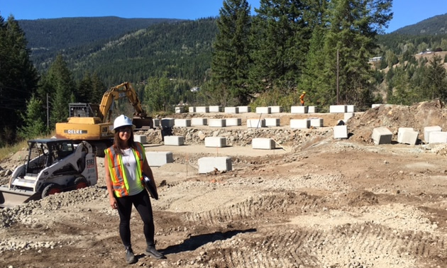 Carmen Proctor is standing in front of the construction site for the solar garden.