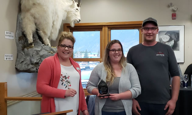 Tammy Odgen (L), chamber executive vice-president, hands the New Business Award to Jenise Casely and Chris Gerlach, new owners of Rocky Mountain Meats.