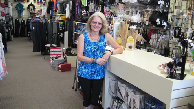 Owner of Sue's Clotheslines in Creston, Sue Thomas stands near her front counter.