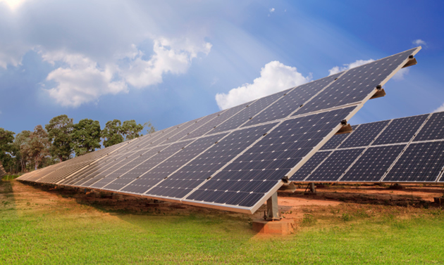 Two large solar panels collect energy beneath a blue sky. 