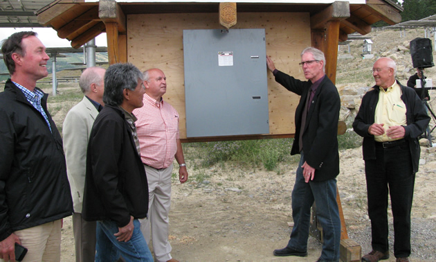 Don McCormick (second from right) prepares to throw the ceremonial switch to activate the SunMine solar panels.